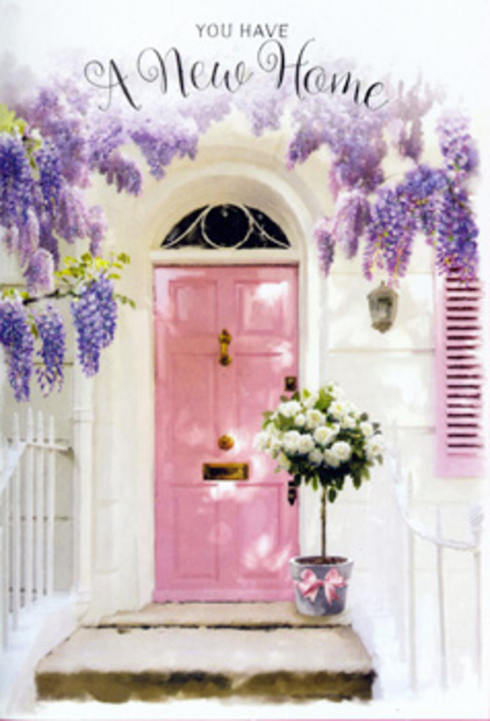 The photograph presents a doorway that feels at once intimate and quietly celebratory, like something you might glimpse wandering the quieter corners around Blackfriars Bridge on a still day. At its centre is a front door painted in a muted pink, a hue that sits somewhere between blush and rose, lending an immediate sense of warmth and approachability. The paint appears matte, so it diffuses the light rather than reflecting it, giving the door a velvety, almost tactile presence. Draped above and cascading along either side, wisteria blooms in generous strands. Each trailing garland is a tumble of small petals in layered shades of lavender, lilac, and soft purple, the individual clusters hanging like strings of tiny lanterns. These delicate blooms partially veil the whitewashed walls, whose subtle texture and off-white tone keep the scene bright without feeling stark. A single pastel shutter, left slightly ajar, contributes another note of pale, chalky colour, adding to the overall softness. On the doorstep rests a straightforward grey metal bucket, its industrial simplicity providing an elegant contrast to the lushness of the flowers. From it, white and cream roses rise in a full, abundant bouquet, their petals thick and layered, curving outwards in generous spirals. Sprigs of soft green foliage peek between the blooms, introducing depth and a gentle asymmetry that speaks of a florist's skilled, relaxed hand-just the sort of touch you'd expect from a local Blackfriars flower studio accustomed to city doorsteps and riverside flats. Around the base of the bucket, a pink ribbon is tied snugly, its colour echoing the door and completing the pastel story. Together, these details create a scene that quietly narrates the emotions of moving in: a house-warming, a first evening in a new home, or a thoughtful floral delivery placed precisely where it can whisper, you are welcome here.